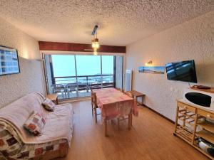 a living room with a table and a view of the ocean at Appartement Saint-Michel-de-Chaillol, 2 pièces, 4 personnes - FR-1-393-3 in Saint-Michel-de-Chaillol