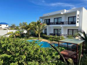 a view of a house with a swimming pool at Minah Bungalows in Nungwi