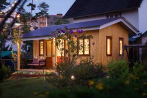 a small house with a garden in the yard at La Em Boutique Villa in Da Lat
