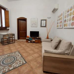 ein Wohnzimmer mit einem Sofa und einem TV in der Unterkunft Nel Cuore del Barocco in Lecce