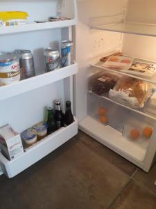 an open refrigerator filled with lots of food and drinks at Thorbecke Canal View 42m2 Loft in Zwolle
