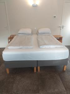 a bed with two pillows on it in a room at Thorbecke Canal View 42 m2 Loft in Zwolle