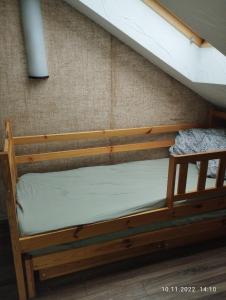 a wooden bunk bed in the corner of a room at Add Story Guest House in Rēzekne