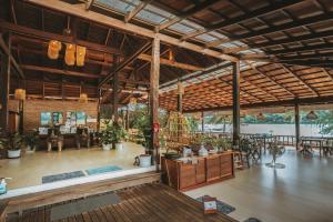 a large room with tables and chairs in a building at Koh Kood Resort in Ko Kood