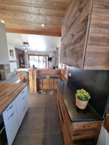 a kitchen with wooden walls and a counter top at Chalet le Petit Ramoneur in Châtel