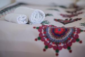 a pair of towels sitting on top of a bed at Na Kamieńcu in Czarny Dunajec