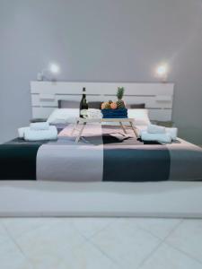 een groot bed met een tafel erop bij Sikelia House Cefalù in Cefalù