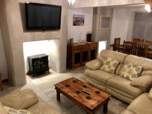 a living room with a couch and a fireplace at Tegfan Victorian terrace Cottage Snowdonia Llanberis in Llanberis