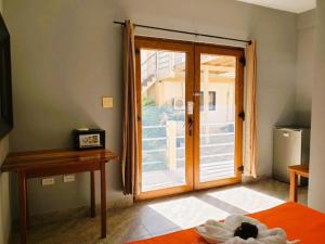 a bedroom with a door open to a patio at Beach Club Condos at Popeyes in Caye Caulker