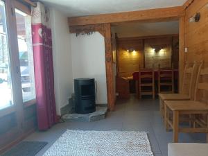 a living room with a stove and a dining room at Three Bedroomed Chalet Apartment in Chamonix