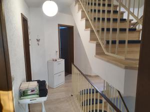 a hallway with a staircase and a stair case at 5 Zimmer Appartement in ruhiger Lage nähe Heilbronn in Oedheim