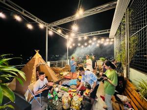 a group of people standing around a table in a tent at MID NIGHT in Can Tho