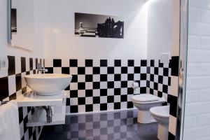 czarno-biała łazienka z umywalką i toaletą w obiekcie Il Castelluccio w Arezzo