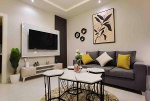 شقة هادئة في موقع مميز ودخول ذاتي في حي الصحافة في الرياض: غرفة معيشة مع أريكة وطاولة