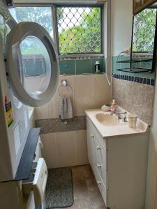 a bathroom with a sink and a mirror at XYL Holiday Inn in Caloundra +161 photos