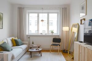 a living room with a white couch and a window at Apartment in central Stockholm in Stockholm