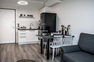 a kitchen with a table with chairs and a couch at Escape Luxury Apartment in Nafplio