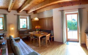 a living room with a table and a couch at Ferienhaus Gerlitzen in Köttwein