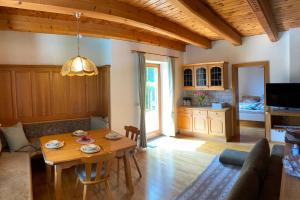 a living room with a table and a couch at Ferienhaus Gerlitzen in Köttwein