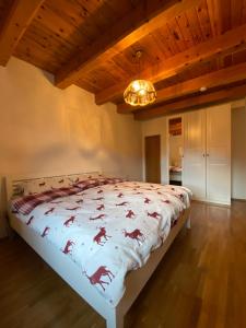 a bedroom with a bed with a horse comforter at Ferienhaus Gerlitzen in Köttwein