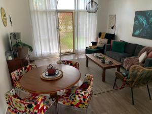 a living room with a table and chairs at Sunshine Four in Salisbury