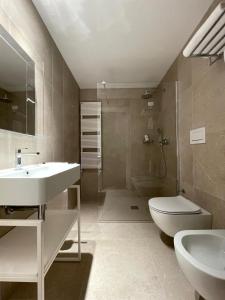 a bathroom with a sink and a toilet and a shower at Hotel Saraceno Al Faro in Taranto