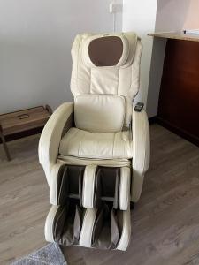 a white reclining chair sitting in a room at relax room in King Abdullah Economic City