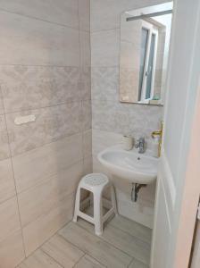 a bathroom with a sink and a mirror and a stool at Villa Ada in Santa Domenica +40 photos