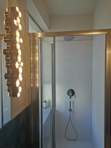 a bathroom with a shower with a glass door at Casa Rocca in Roccaforte Mondovì