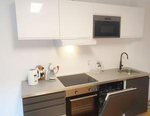 A kitchen or kitchenette at Rooftop Terrace, free garage parking and Pool!