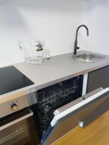 A kitchen or kitchenette at Rooftop Terrace, free garage parking and Pool!