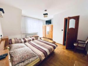 a bedroom with a bed and a couch in it at Pokoje Gościnne Letycja in Biały Dunajec