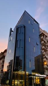 a large glass building with a lot of windows at Black Diamond Hotel in Tirana