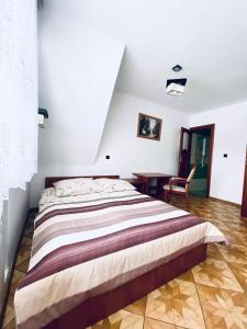 a bedroom with a large bed and a desk at Pokoje Gościnne Letycja in Biały Dunajec