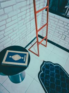 a room with a table and a chair and a stool at El jenna syariah villas in Tjolomadu
