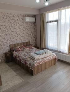 a bedroom with a bed and a window at Mary's Cozy & Lovely studio on very quiet Khosharauli street in Tbilisi City