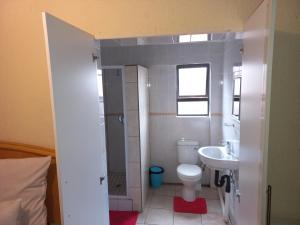 a bathroom with a toilet and a sink at sediba guest house in Krugersdorp