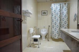 a bathroom with a toilet and a sink at Jubail Inn in Al Jubail +27 photos