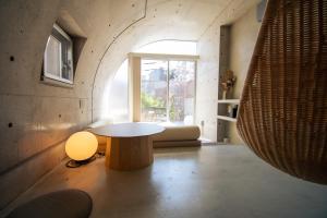 a living room with a table and a window at Boutique Sauna ARCH in Tokyo