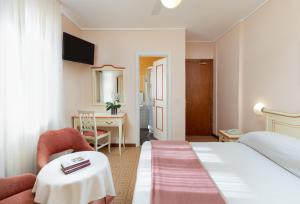a hotel room with a bed and a desk at La Quiete Park Hotel in Manerba del Garda