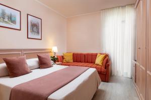 a hotel room with a bed and a couch at La Quiete Park Hotel in Manerba del Garda