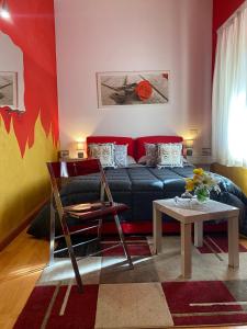 a living room with a couch and a table at Oasi Del Fiumefreddo in Fiumefreddo di Sicilia