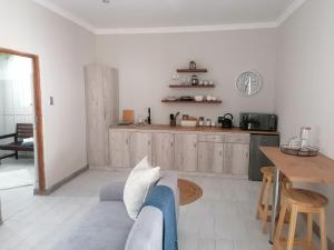 a living room with a couch and a table at On Enslin selfcatering in Middelburg