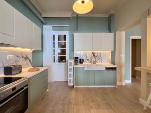 a kitchen with blue and white cabinets and a sink at #Infinity & Beyond seafront apts, amazing view in Thessaloniki