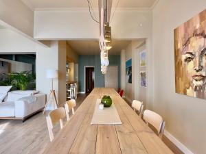 a dining room with a wooden table and chairs at #Infinity & Beyond seafront apts, amazing view in Thessaloniki