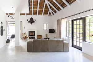 a living room with a couch in the middle at Africa Lodge in Somerset West