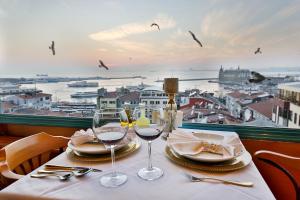 a table with wine glasses and a view of a city at Sidonya Hotel in Istanbul
