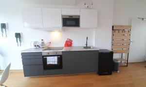 A kitchen or kitchenette at Rooftop Terrace, free garage parking and Pool!