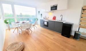 A kitchen or kitchenette at Rooftop Terrace, free garage parking and Pool!