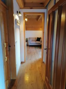 a hallway leading to a living room with a couch at Wellness apartmaji Mimi in Tabor